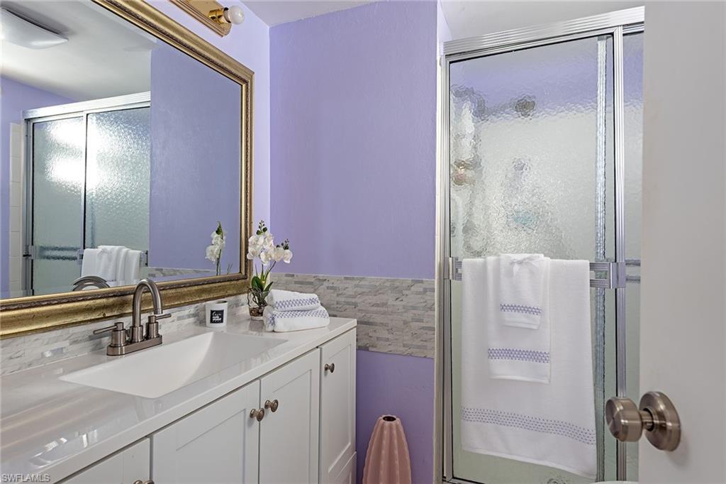 200 Forest Lakes Boulevard, Unit 201 Naples, FL 34105 - Photo 9 of 12 a bathroom with a sink and a mirror