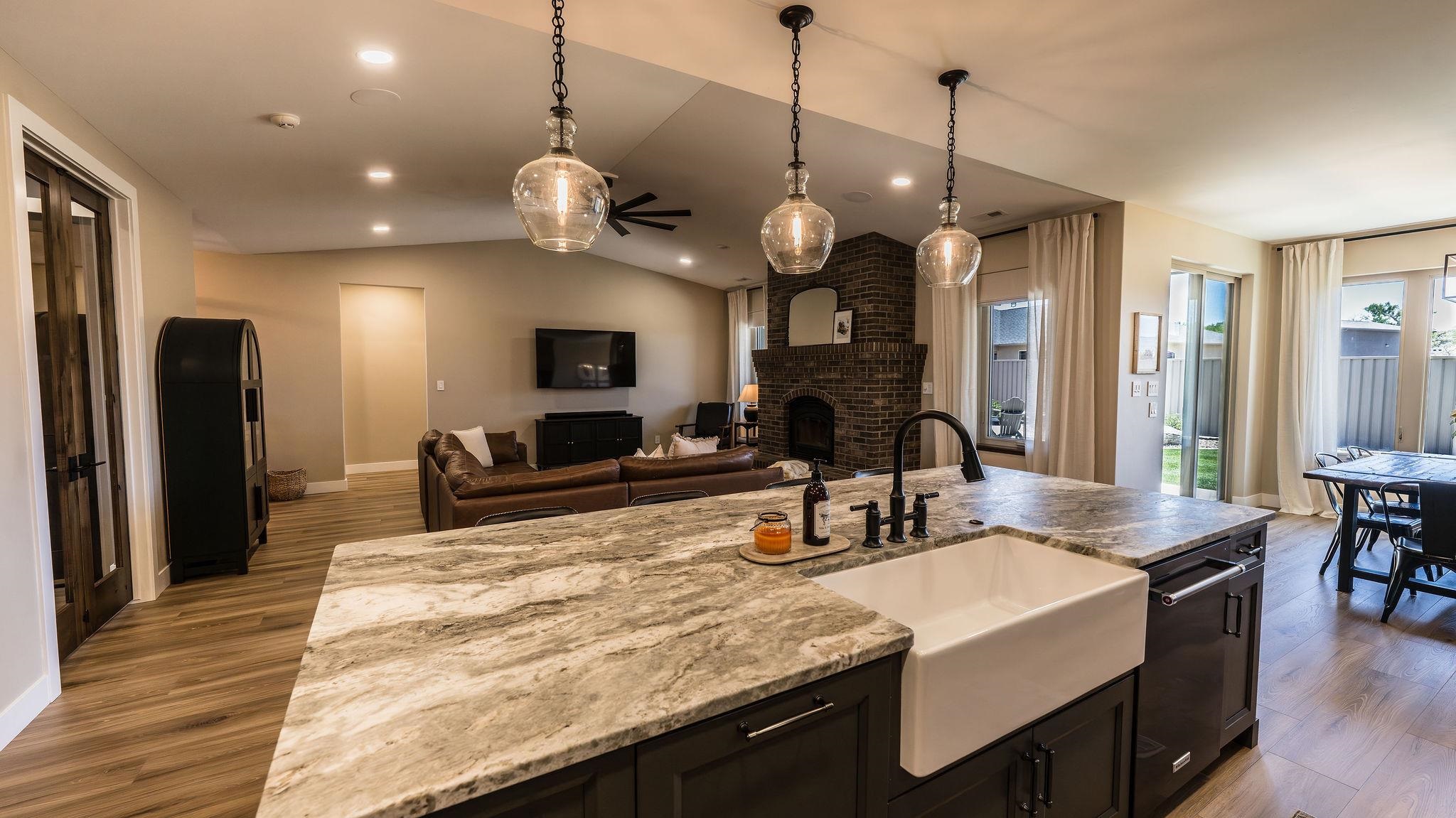2639 Emerald Ridge Lane Grand Junction, CO 81506 - Photo 6 of 42 a large kitchen with granite countertop a sink a center island and stainless steel appliances