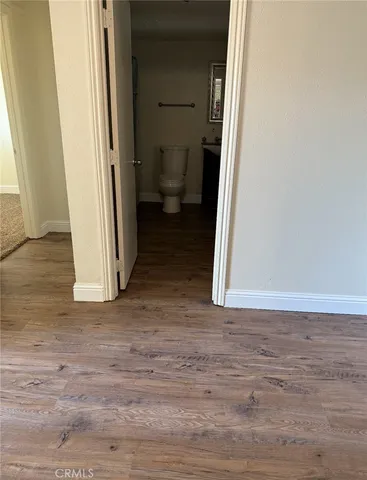 a view of a room with wooden floor and a sink