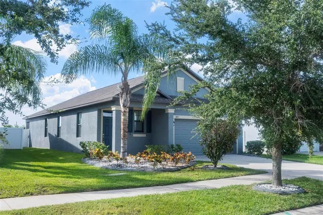 a front view of house with yard and green space