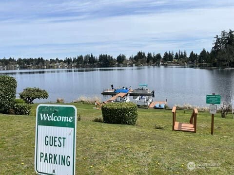 17103 Spanaway Loop Road South, Unit 22 Spanaway, WA 98387 - Photo 6 of 6 a view of a lake with houses in the back
