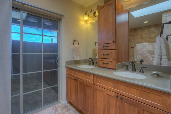 a bathroom with a granite countertop sink a vanity and a mirror