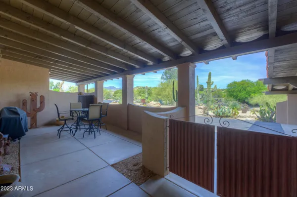 a view of a porch with furniture and a yard