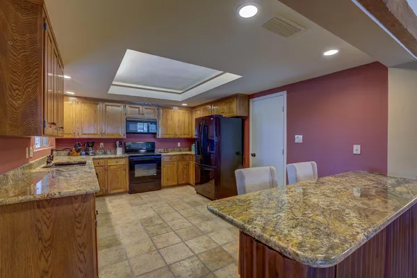 a kitchen with lots of counter top space and stainless steel appliances