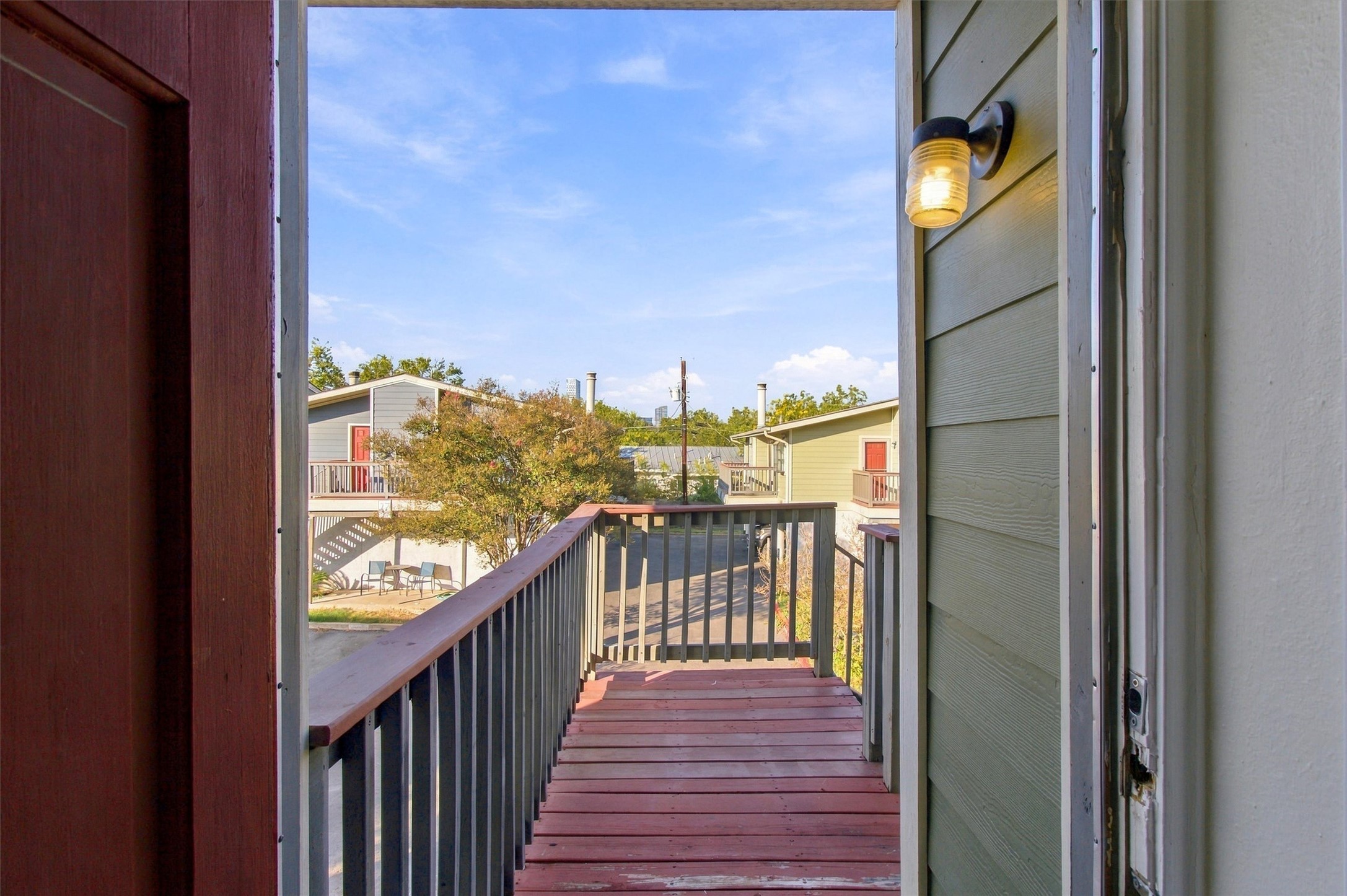 2215 Post Road, Unit 2055 Austin, TX 78704 - Photo 3 of 30 A private wood-planked balcony opens to views of the surrounding neighborhood.