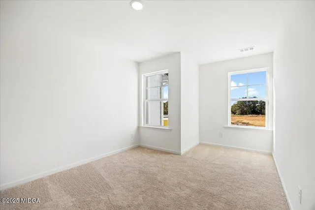 an empty room with windows and closet