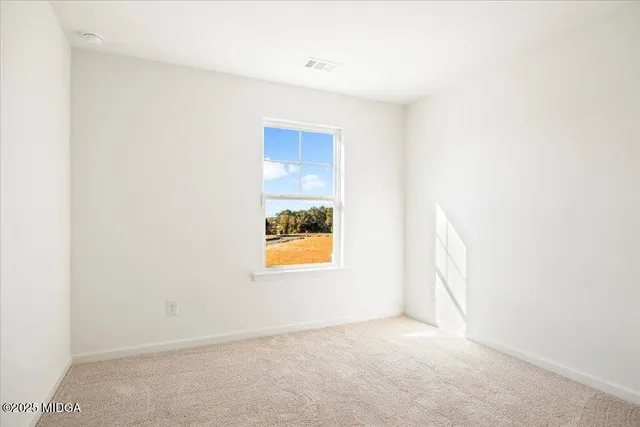 a view of an empty room and a window