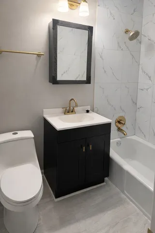 a bathroom with a toilet a sink and bathtub