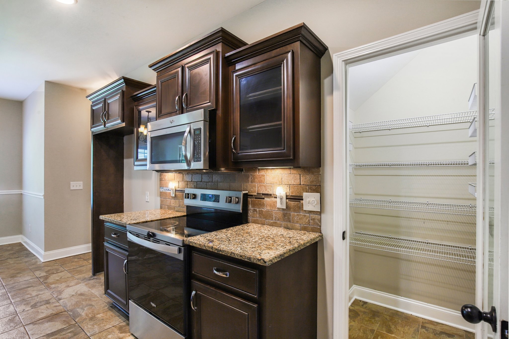 316 Amazonway Ridge Lascassas, TN 37085 - Photo 10 of 36 a kitchen with stainless steel appliances granite countertop a stove and a refrigerator