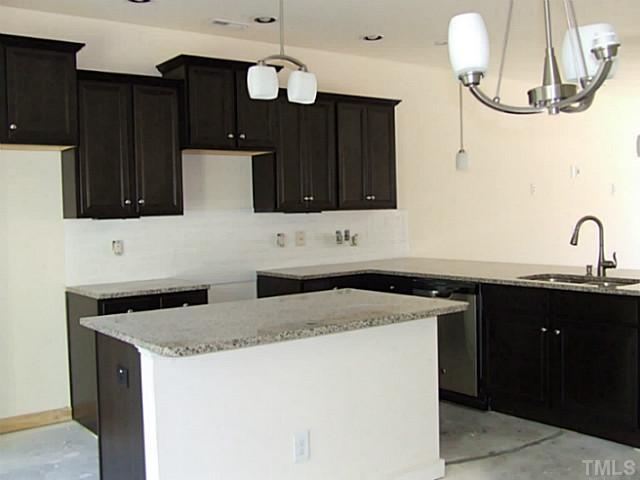7839 Allscott Way Raleigh, NC 27612 - Photo 4 of 5 Ebony cabinets with subway tile backsplash and granite tops.
