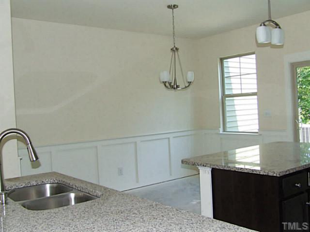7839 Allscott Way Raleigh, NC 27612 - Photo 5 of 5 DR is offset from the kitchen, kitchen has center island and breakfast bar!