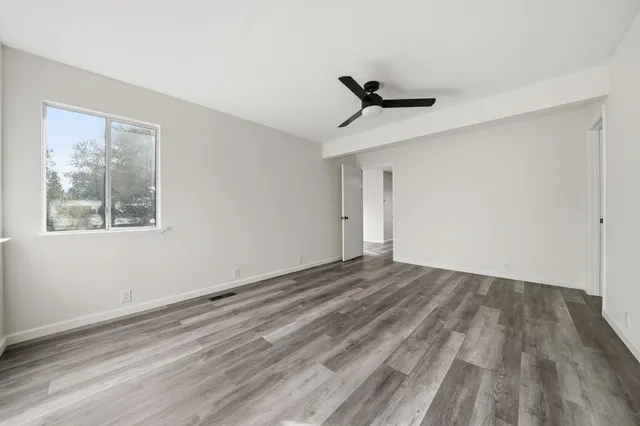 a view of a hallway with wooden floor and entryway