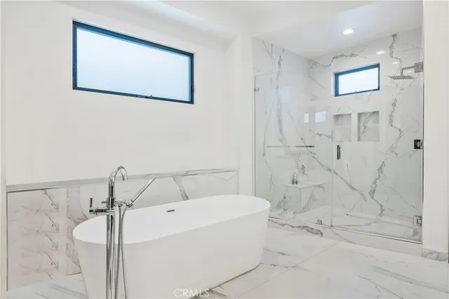 a view of a big room with wooden floor and windows