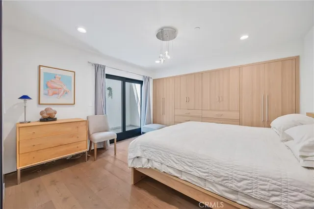 a view of a livingroom with wooden floor and stairs