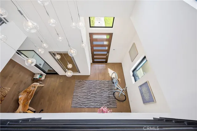a roof deck with table and chairs and potted plants