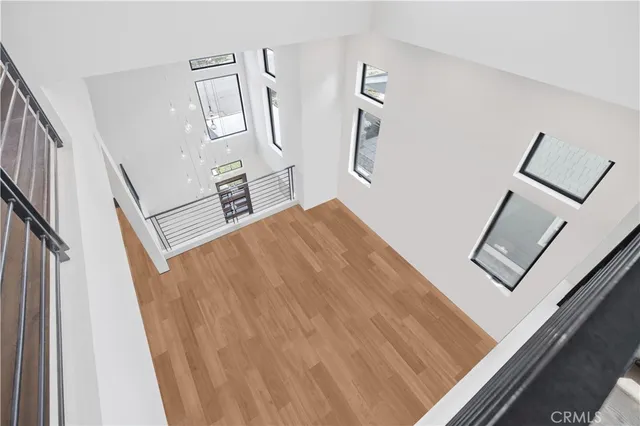 a view of a dining room with furniture a chandelier and wooden floor