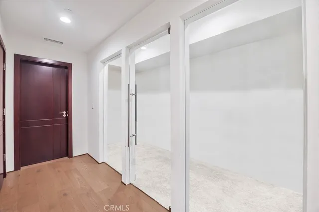 a view of walk in closet with clothes