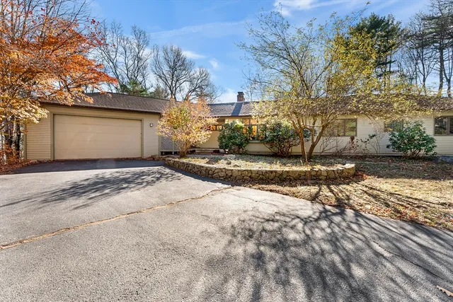 a view of a house with a wooden deck
