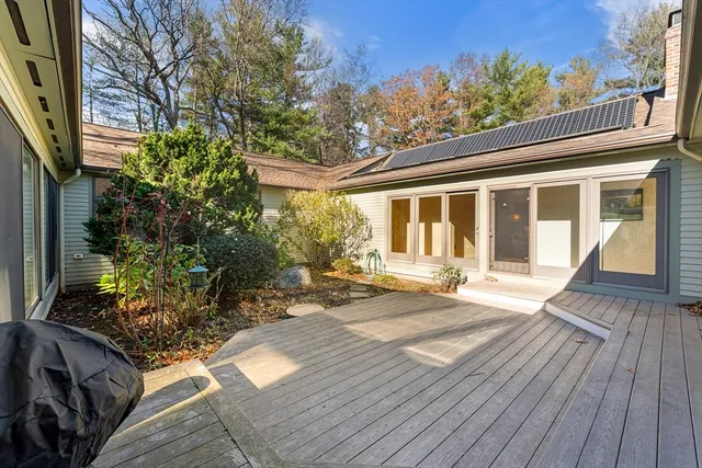 a bathroom with a granite countertop sink a toilet and a shower