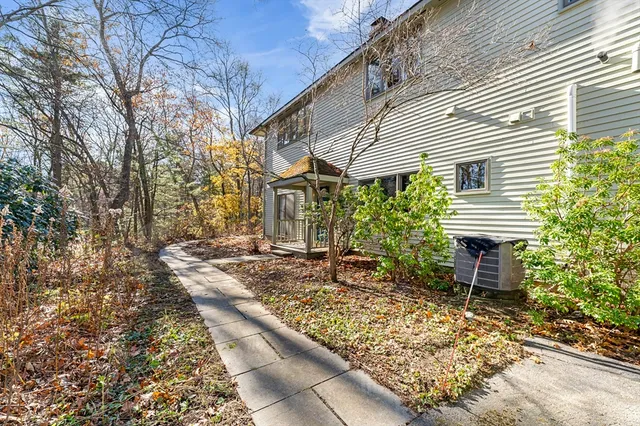 a bedroom with a bed and a large window with balcony view
