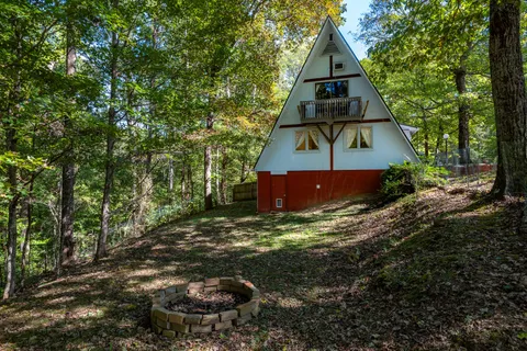 a backyard of a house with barbeque oven table and chairs