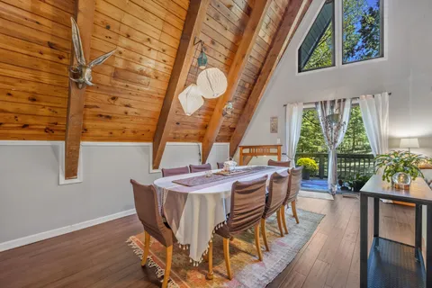 a dining room with furniture and wooden floor