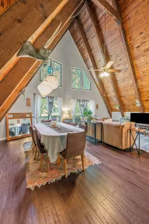a view of a patio with table and chairs with wooden floor and fence