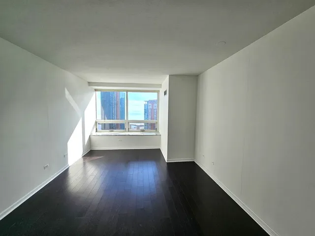 a view of a room with wooden floor and windows