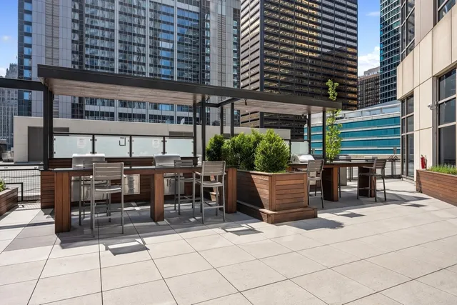 a view of a patio with table and chairs potted plants
