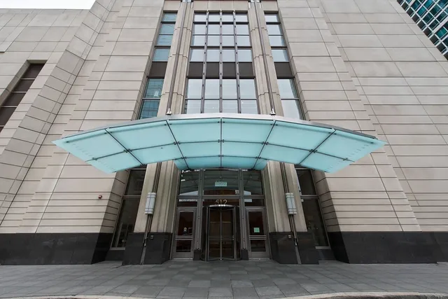 a view of a patio with table and chairs under an umbrella