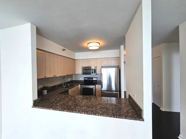 a kitchen with a refrigerator sink and stove