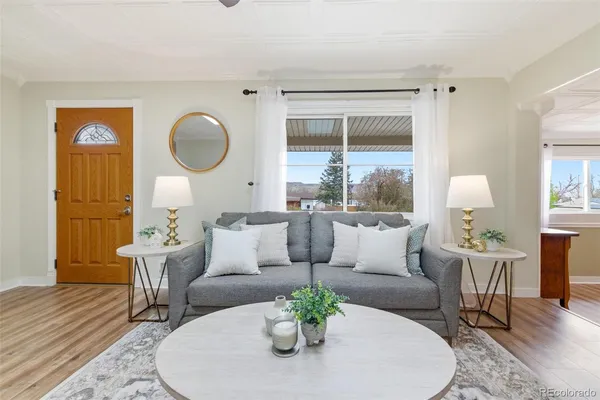 a living room with furniture a fireplace and a chandelier