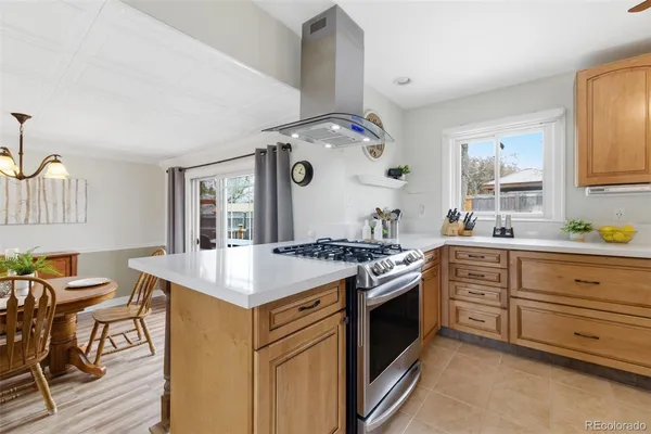 a kitchen with a stove and a white cabinets