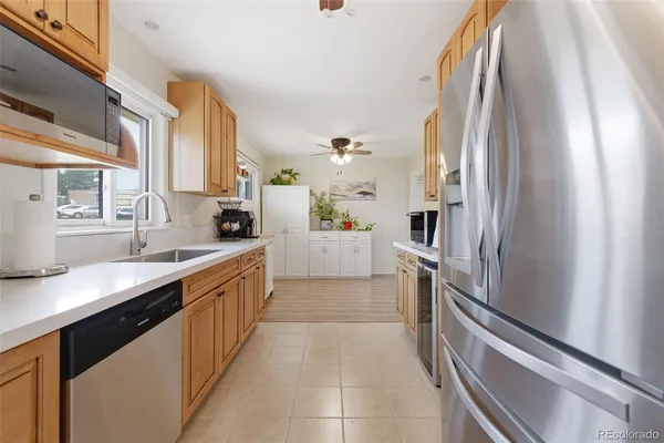 a kitchen with cabinets stainless steel appliances a sink and a window