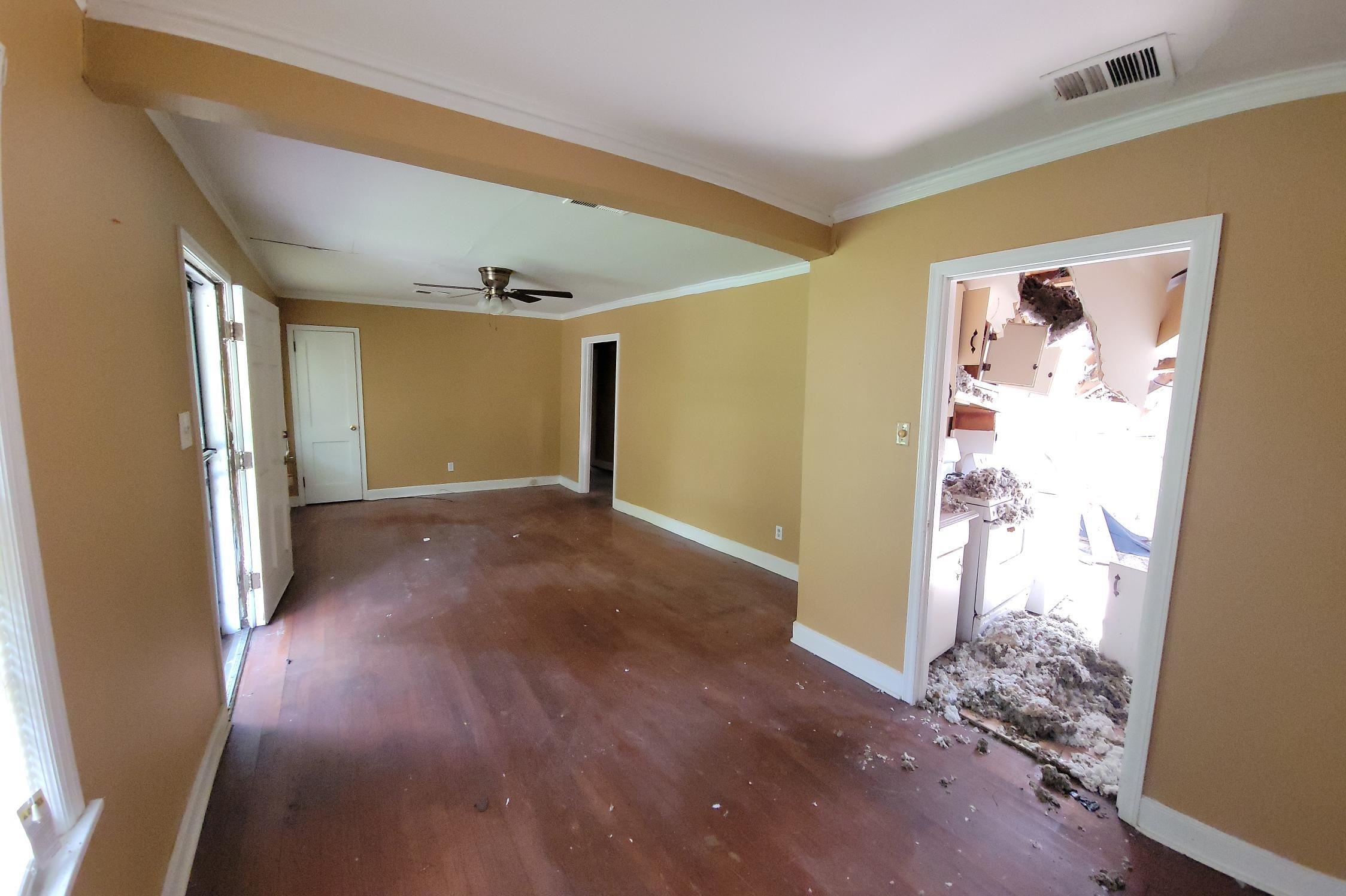 963 Rutgers Road Memphis, TN 38106 - Photo 8 of 21 a view of a hallway with wooden floor and a workspace