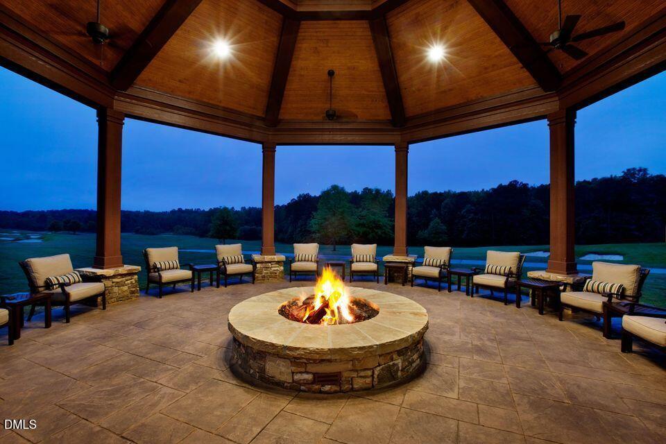 1329 Sandybrook Lane Wake Forest, NC 27587 - Photo 12 of 16 a living room with patio fireplace furniture and a potted plants