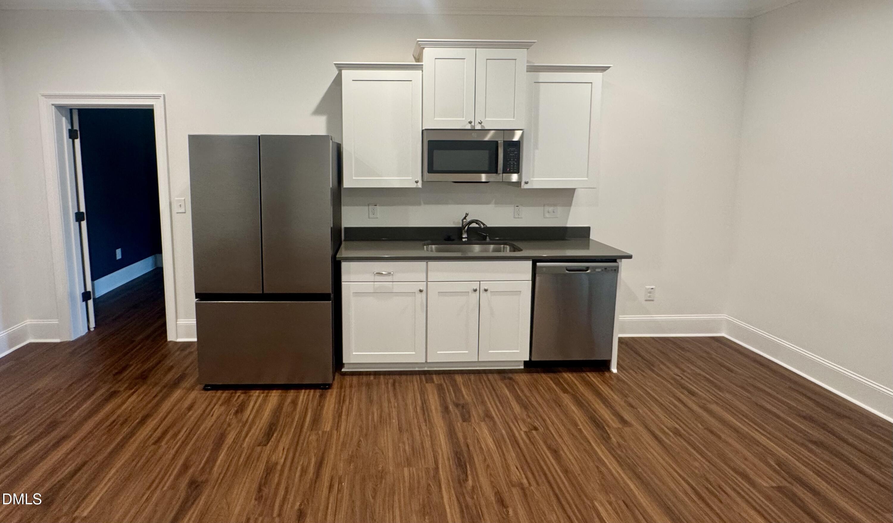 1329 Sandybrook Lane Wake Forest, NC 27587 - Photo 4 of 16 a kitchen with wooden floors and appliances