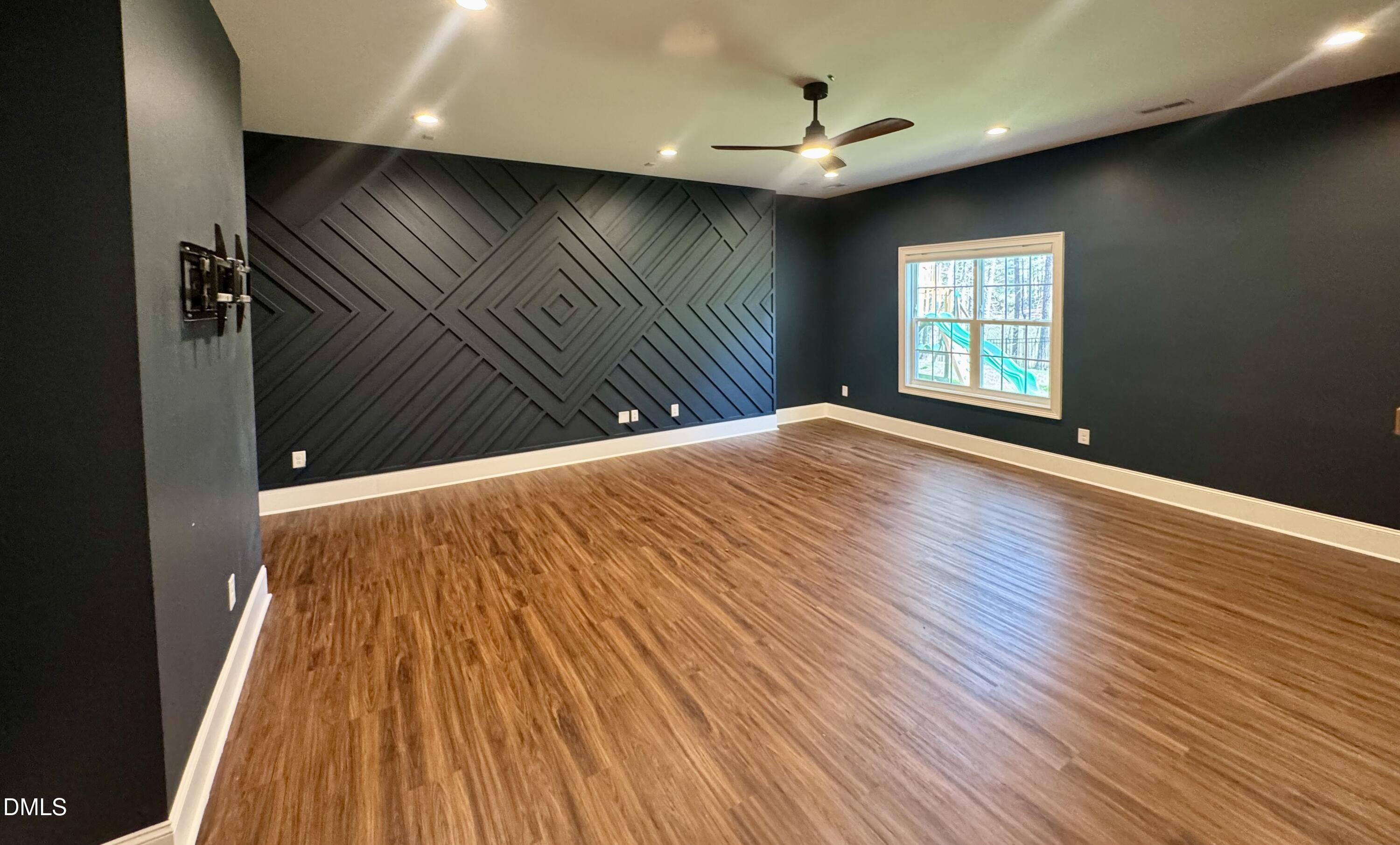 1329 Sandybrook Lane Wake Forest, NC 27587 - Photo 6 of 16 a view of an empty room with wooden floor and a window