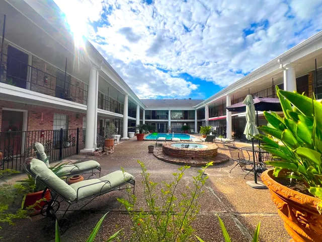 a view of a patio with couches chairs and potted plants