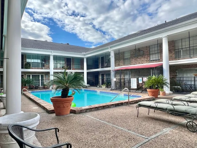 a building outdoor space with patio furniture and potted plants