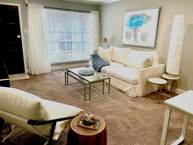 a living room with furniture and a window