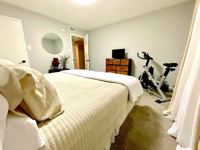 a bedroom with a bed and a chandelier