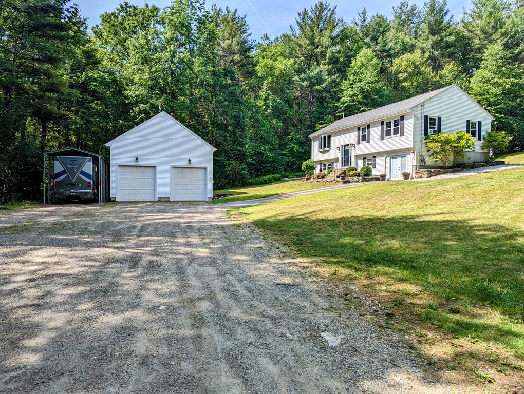 56 Colburn Road Charlton, MA 01507 - Photo 1 of 40 a front view of a house with a yard and garage
