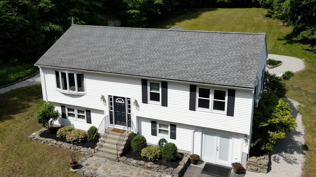 56 Colburn Road Charlton, MA 01507 - Photo 39 of 40 a aerial view of a house with a yard and potted plants