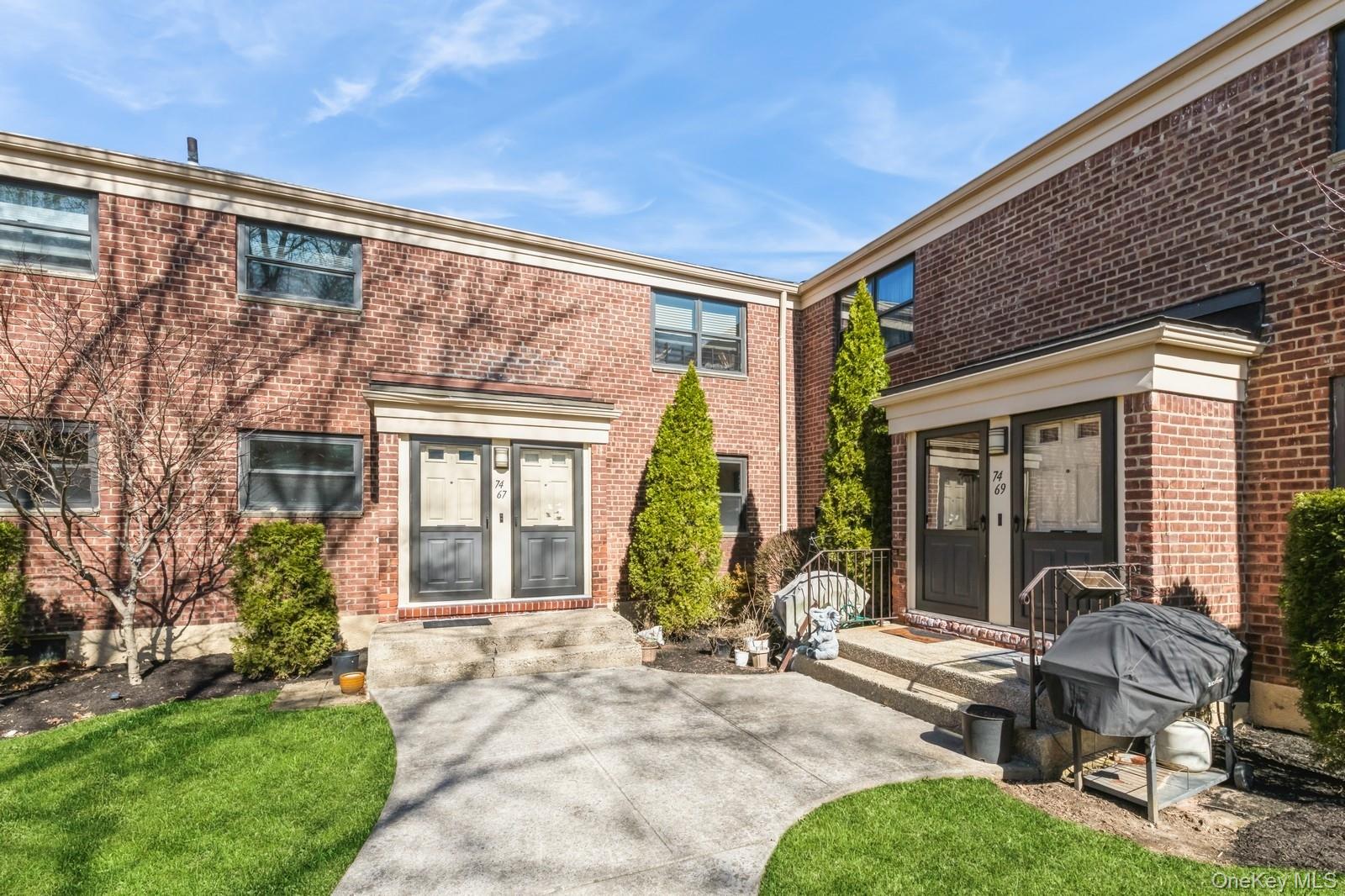 74-67 220th Street, Unit 101A Queens, NY 11364 - Photo 2 of 15 Rear view of house featuring brick siding