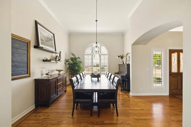 a kitchen with stainless steel appliances granite countertop a sink a stove and a wooden floors