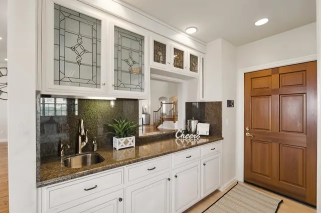 a kitchen with a sink stove and cabinets