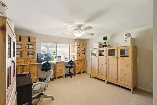 a bathroom with a granite countertop shower a toilet and a sink