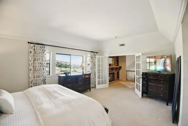 a green field with some trees in the background