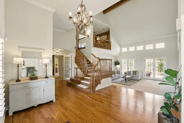 a view of a living room and kitchen with windows